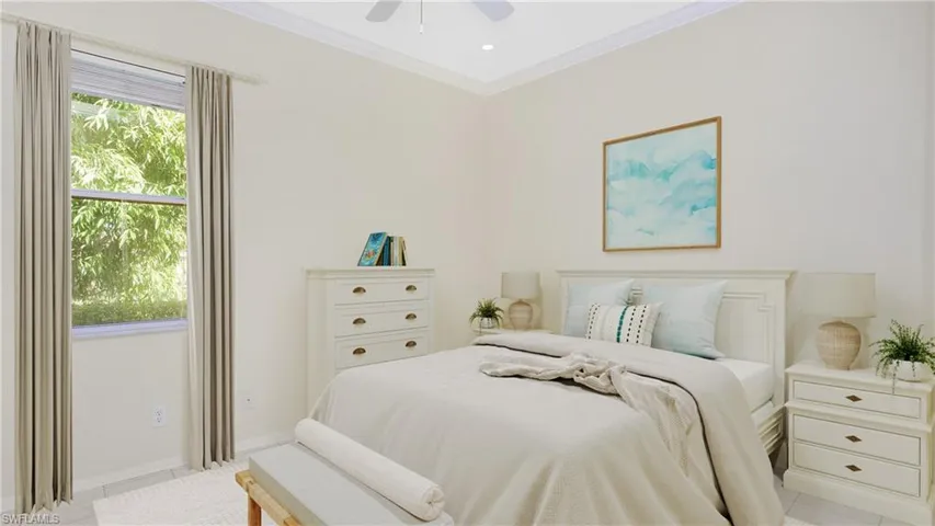 Bedroom with ceiling fan, light tile patterned flooring, and crown molding