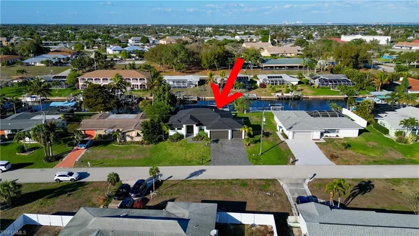 Aerial perspective of suburban area featuring a nearby body of water