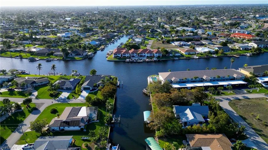 View of property location featuring a large body of water and nearby suburban area