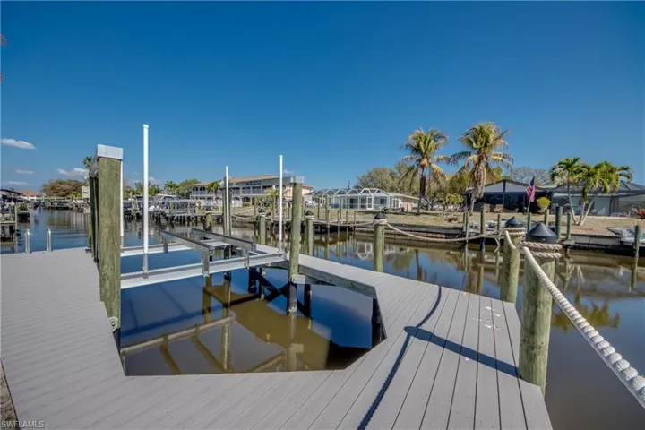 Dock with boat lift and a water view
