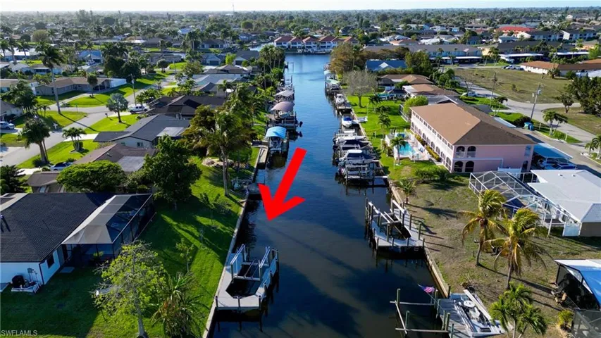Aerial view of residential area featuring a nearby body of water
