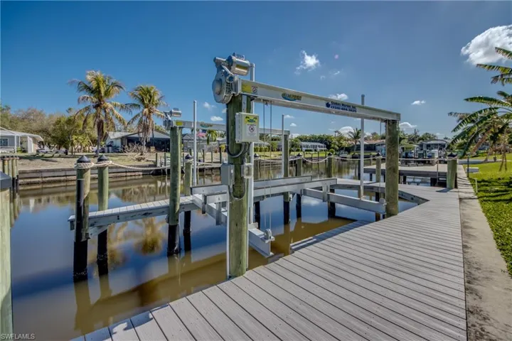 Dock area with boat lift and a water view