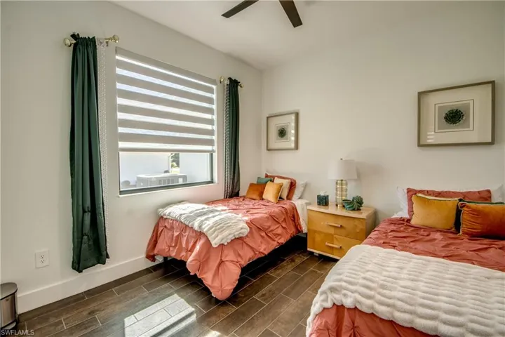 Bedroom featuring wood finish floors and a ceiling fan
