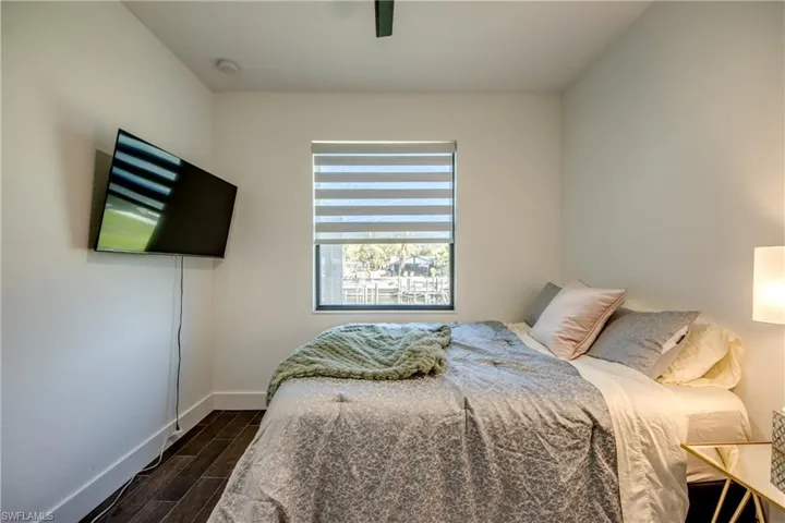 Bedroom with wood finish floors and a ceiling fan