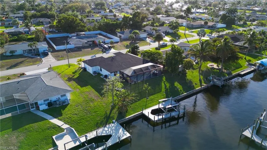 Aerial view of residential area featuring a large body of water