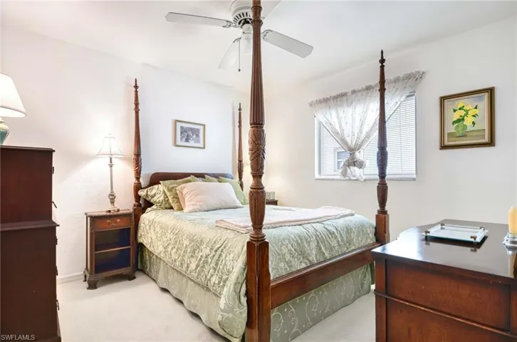 Bedroom featuring light colored carpet and ceiling fan