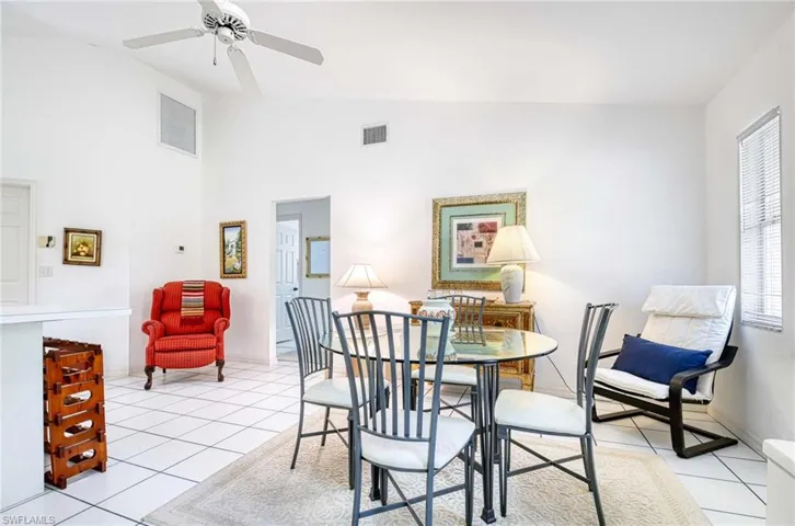 Dining area with light carpet and a high ceiling