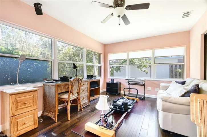 Office space featuring a ceiling fan and dark wood-style floors