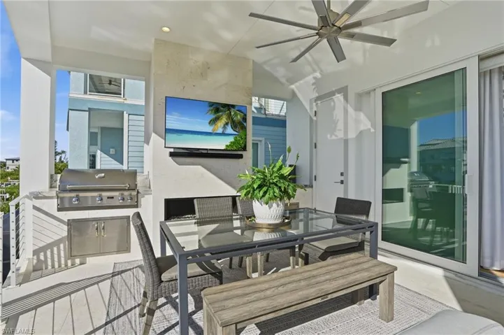Gas grill, fireplace, dining area, television.