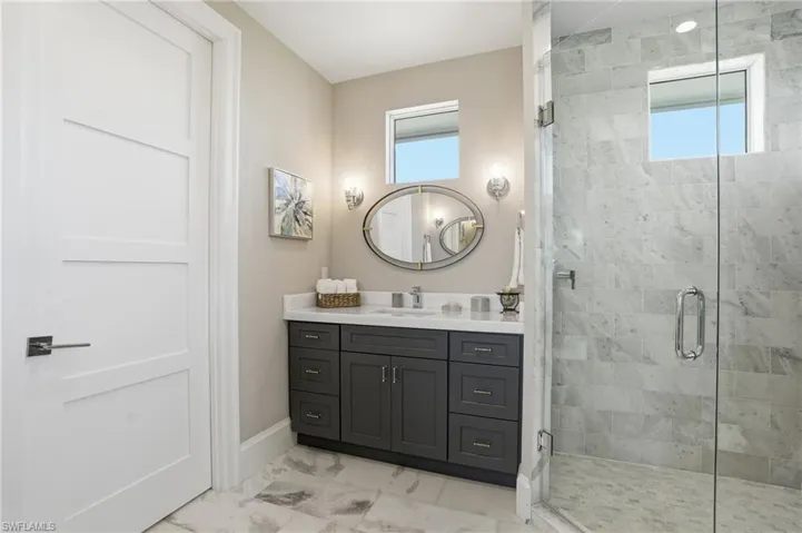 2nd primary ensuite, dual vanities, walk-in glass shower, oversized walk in closet, private water closet.
