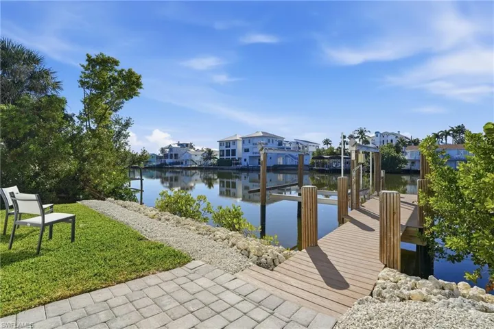 Composite dock w/ lift overlooking the water. Dolphins in your backyard, it's a good thing.