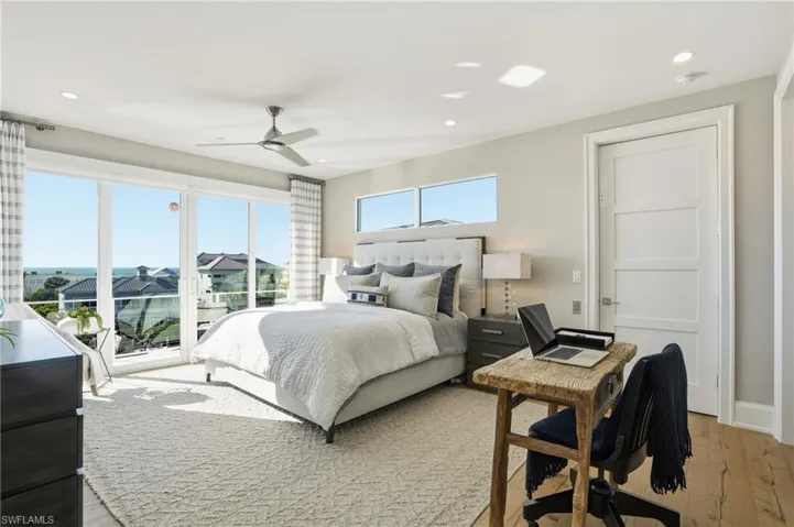 Ensuite, walk-in closet with built-ins, outdoor balcony, private elevator, oak hardwood floor, impact slider, motorized window treatments.