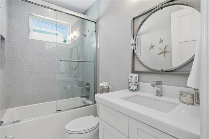 Glass shower, tub combo. Designer tile and finishes.