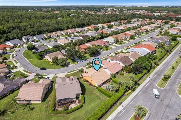 Aerial view of property and surrounding area with nearby suburban area