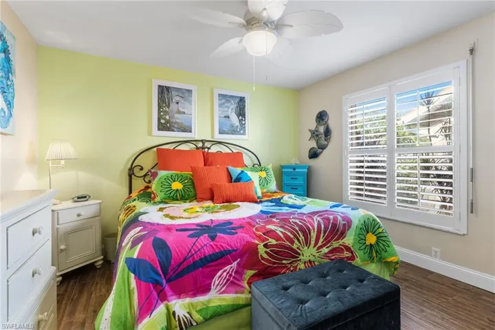 Bedroom with dark wood-type flooring and ceiling fan