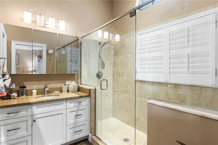 Bathroom with vanity and a shower stall