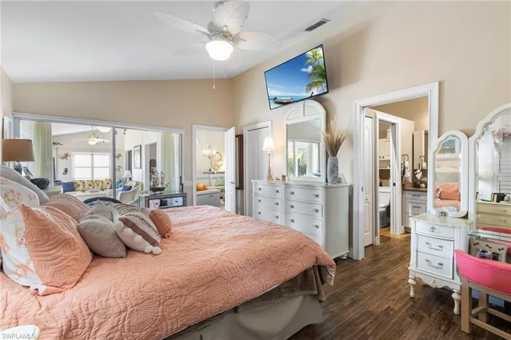Bedroom featuring lofted ceiling, dark wood finished floors, and a ceiling fan