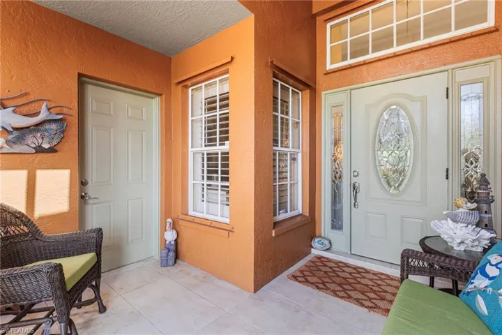 View of exterior entry featuring stucco siding