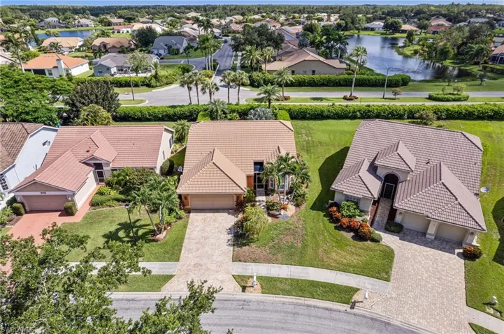 Aerial perspective of suburban area with a nearby body of water