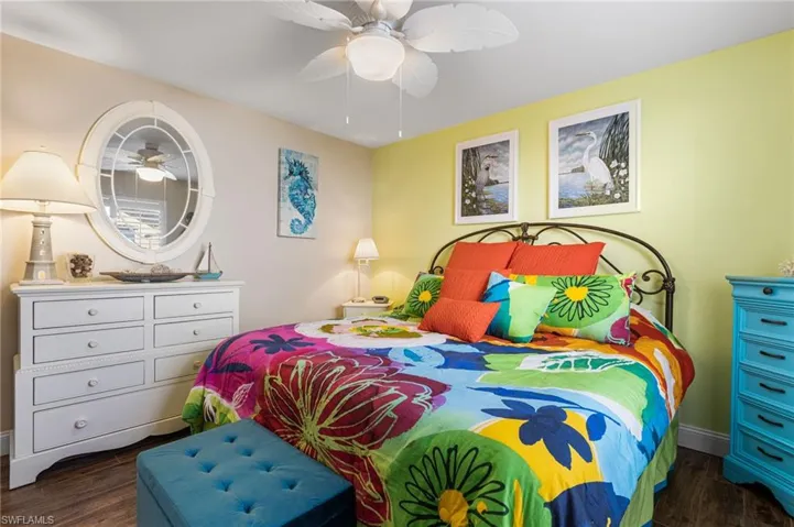 Bedroom with dark wood-type flooring and ceiling fan
