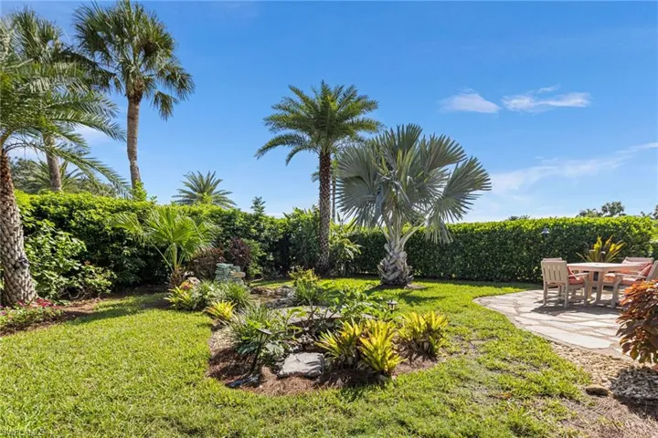 View of grassy yard with a patio area