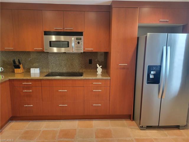Stainless steel appliances with granite counter and back splash.