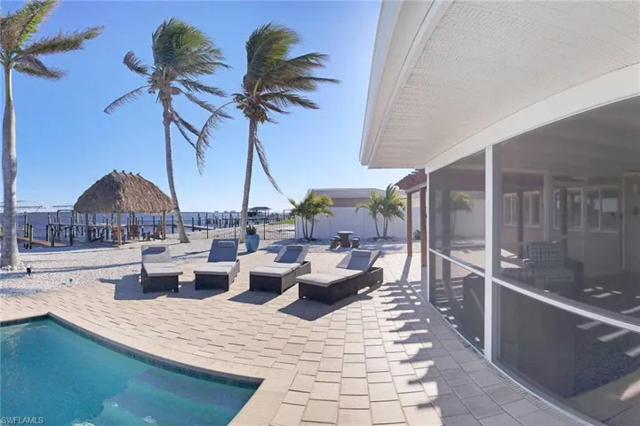 Heated saltwater pool features ample brick paver decking and room for lounging with family & guests while watching the Dolphins and Manatee play!