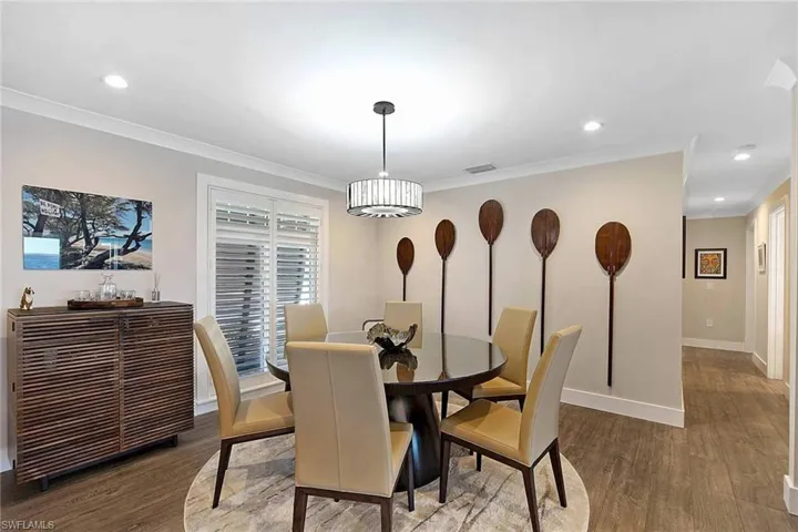 Dining area with hallway to bedrooms, baths, & laundry