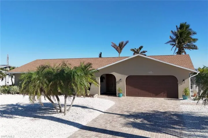 Front of Home - all shell yard for easy care! Lovely brick paver driveway and ample parking for guests.
