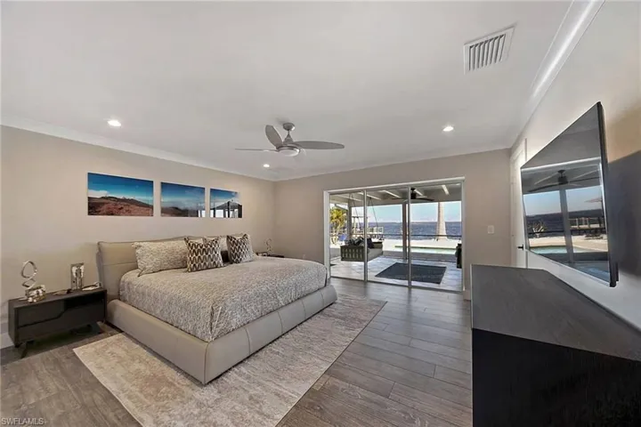Primary Bedroom with pocketing triple glass sliders leading to the huge Lanai!