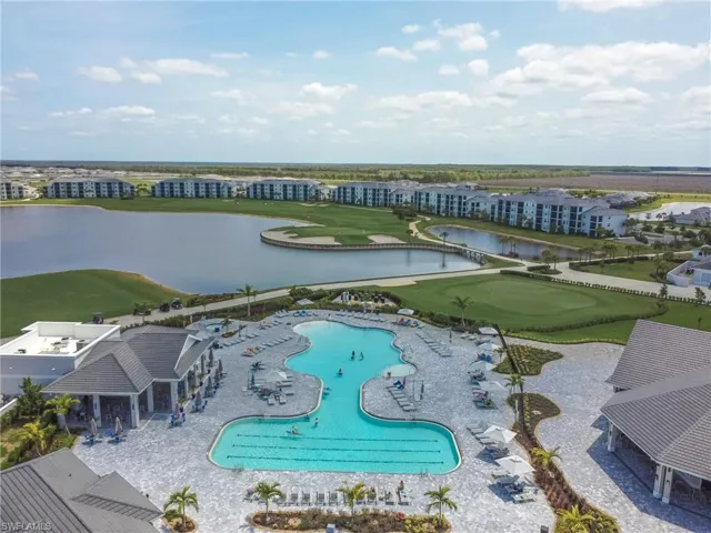 Aerial view of a nearby body of water, a pool area, and a golf club