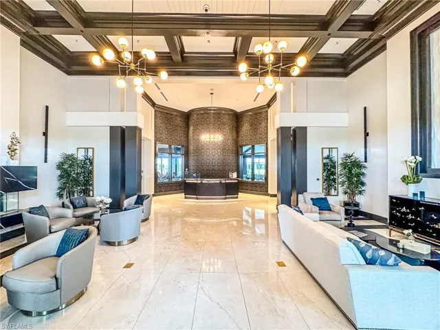 Lobby with a towering ceiling, coffered ceiling, and crown molding