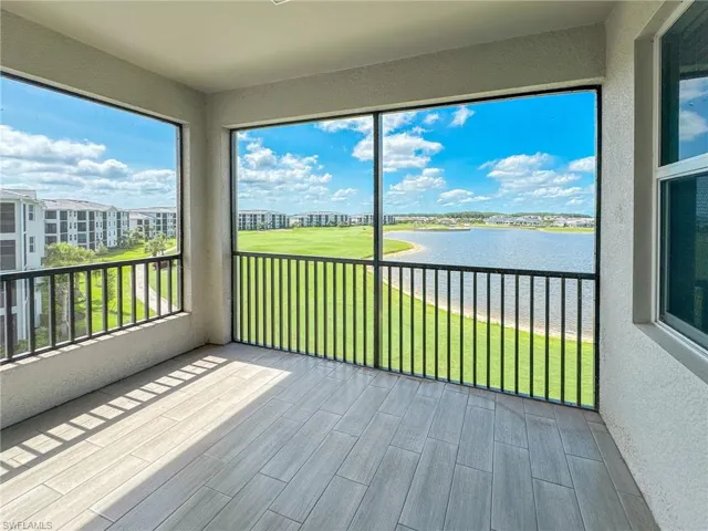 Unfurnished sunroom featuring a water view