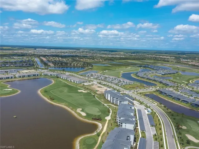 Aerial perspective of suburban area featuring a large body of water and a local golf course