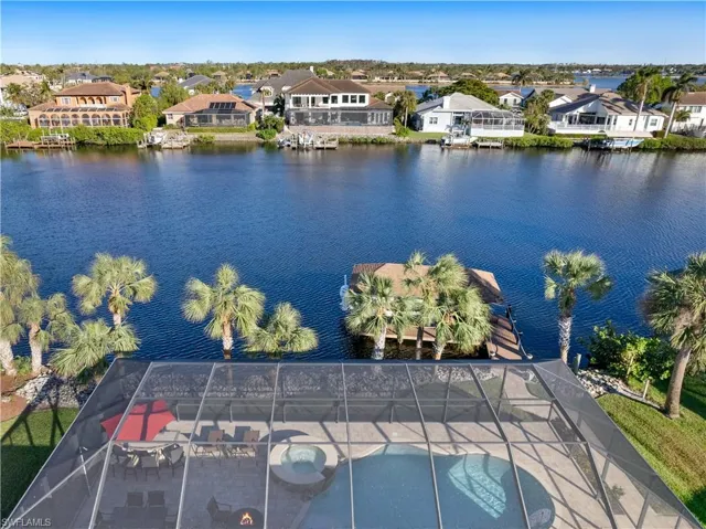 Birds eye view of property with a water view