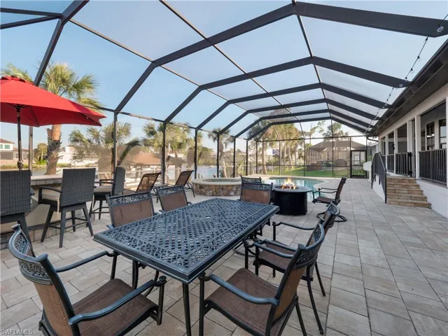 View of patio / terrace with an outdoor bar and a lanai