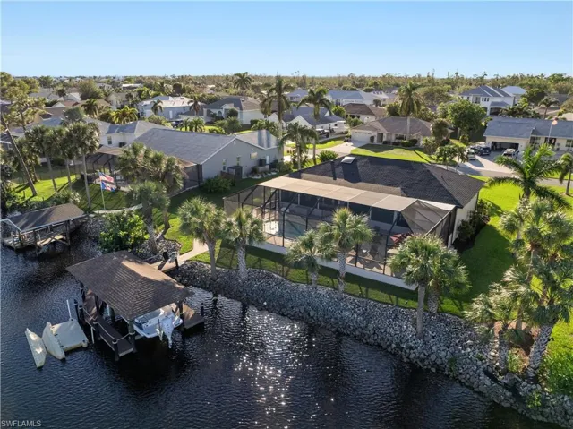 Birds eye view of property with a water view