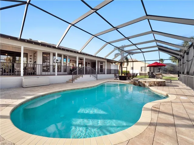 View of pool with a lanai, a patio area, and an in ground hot tub