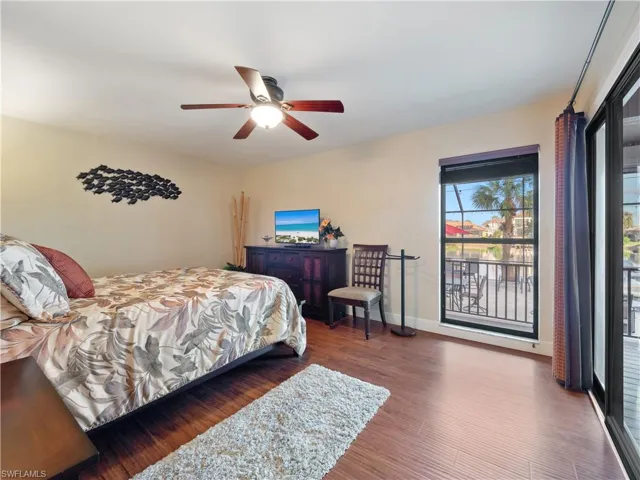 Bedroom featuring ceiling fan and dark hardwood / wood-style floors