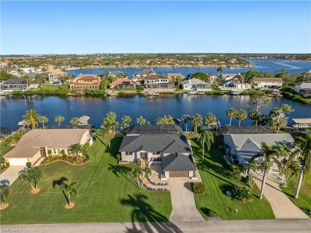 Birds eye view of property with a water view