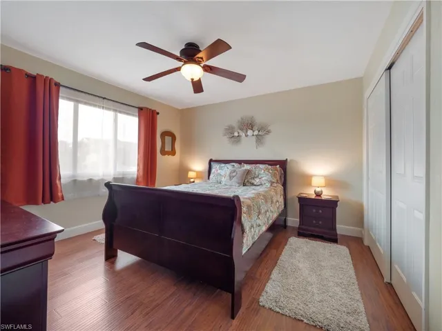 Bedroom with ceiling fan, a closet, and hardwood / wood-style flooring