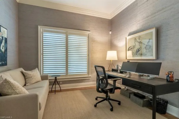 Office featuring crown molding and wallpapered walls
