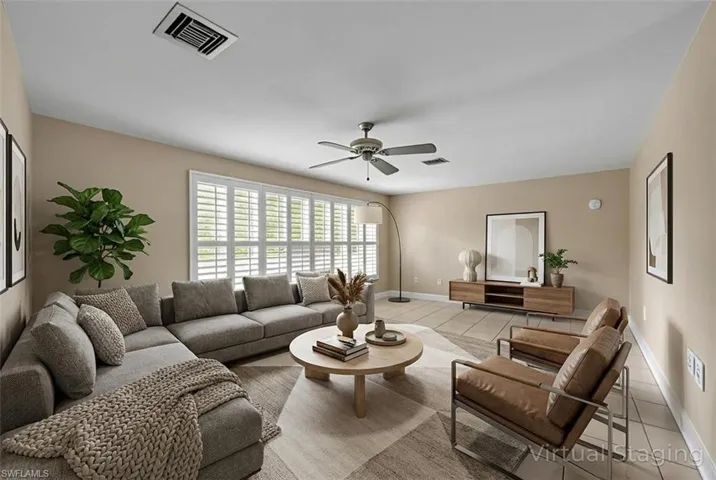 Tiled living room with baseboards and ceiling fan