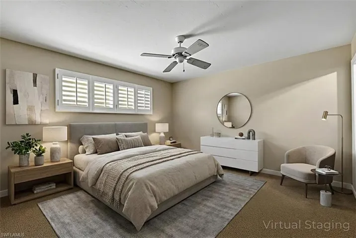 Bedroom with a ceiling fan and carpet flooring