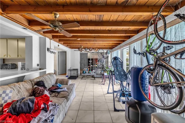 Sunroom featuring beam ceiling