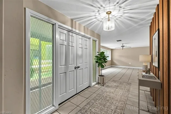 Foyer with hanging lights and ceiling fan