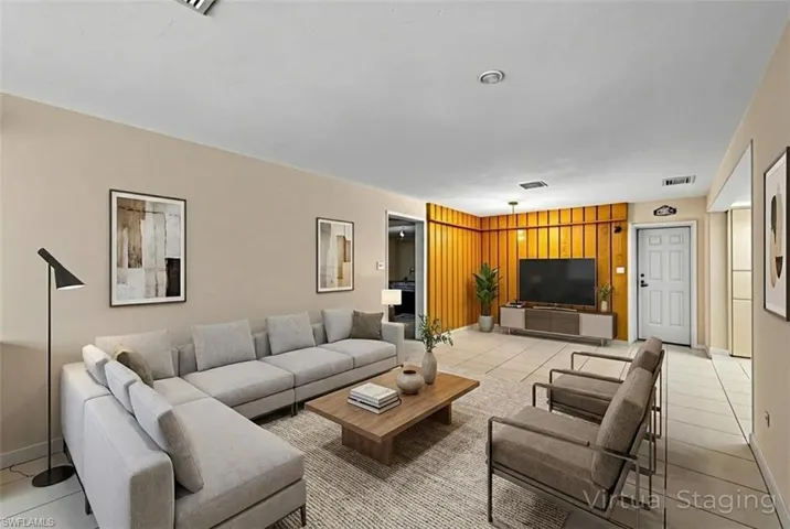 Living room featuring light tile patterned flooring and baseboards
