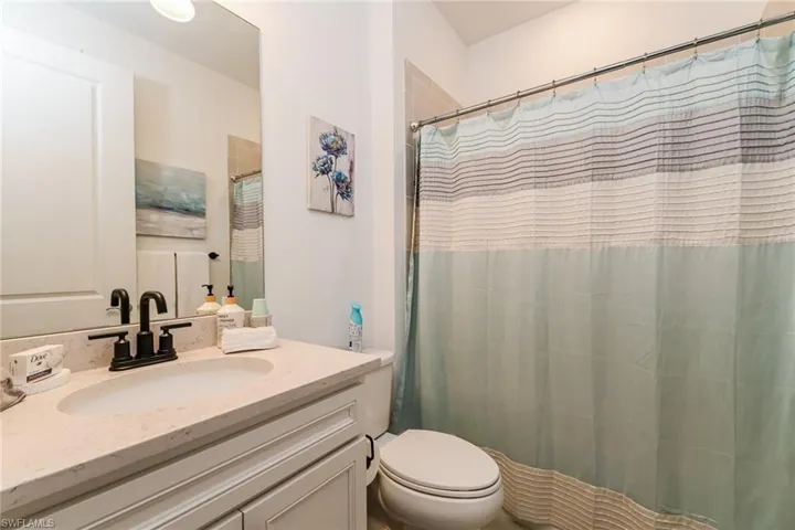 Full bathroom with vanity and curtained shower