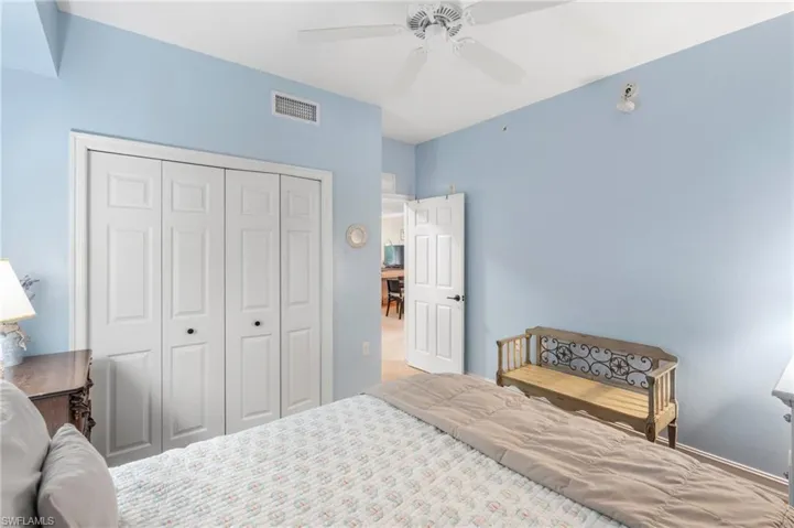 Bedroom with a closet, ceiling fan, and visible vents