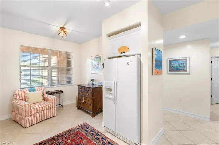 Sitting room with light tile patterned flooring and baseboards